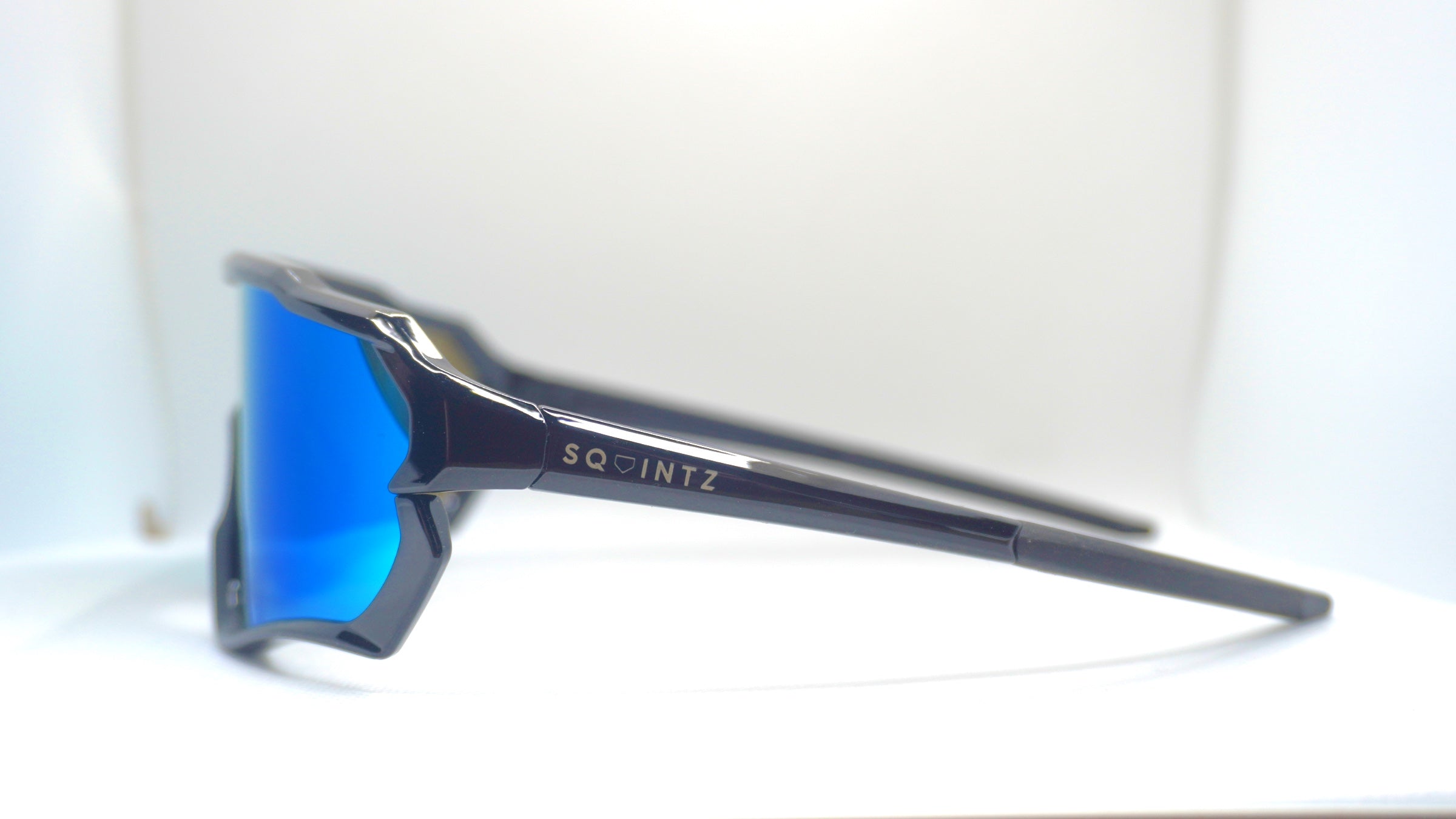 Close side view showing the Squintz logo on the sunglasses arm